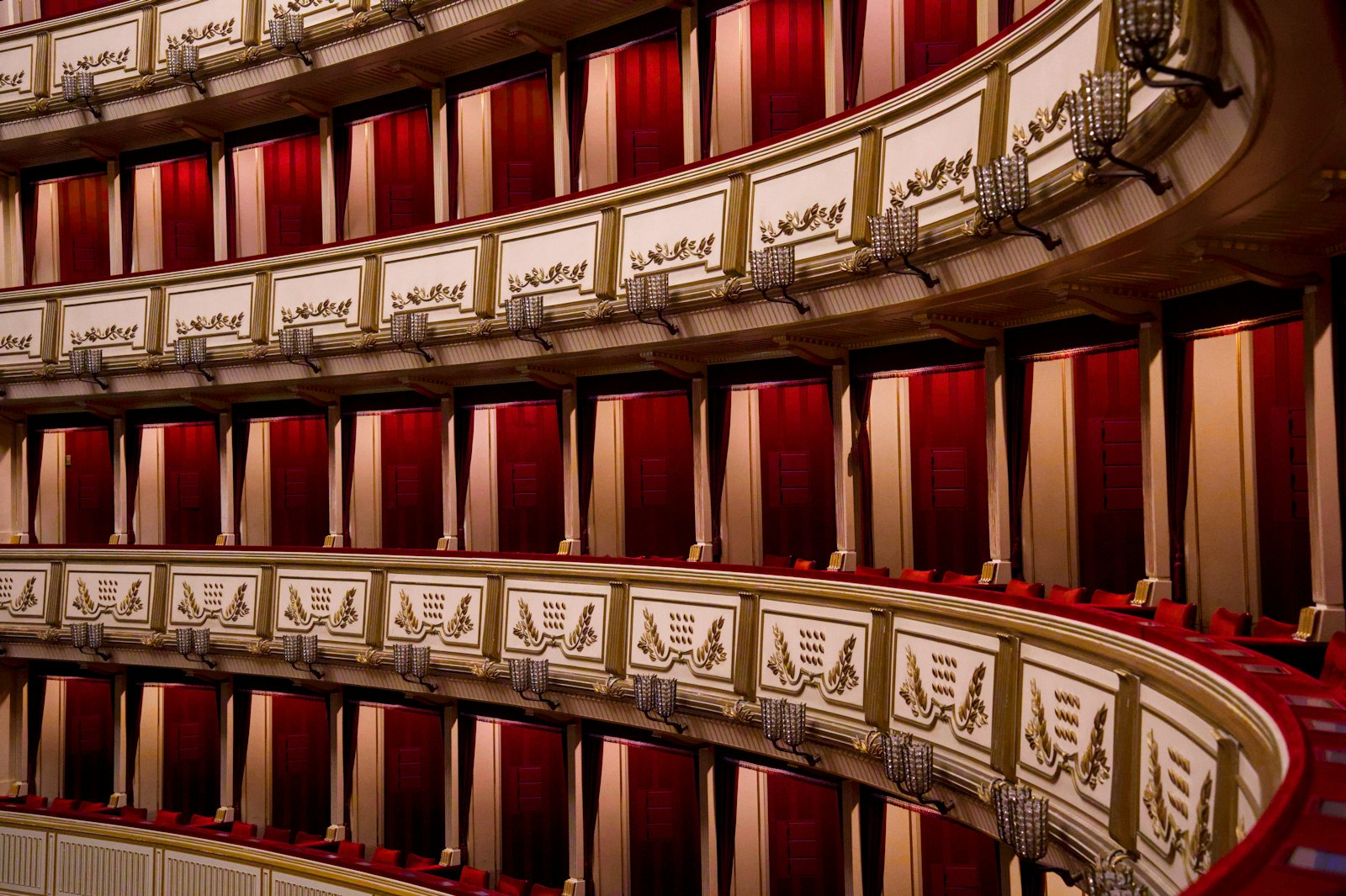 Mehrere Ränge mit roten Logen in einem klassischen Opernhaus